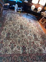 Full view of rug on floor, showing overall pattern and dimensions