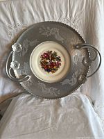 Full front view of platter showing ceramic center, hammered aluminum rim, handles