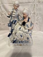 Front view of porcelain courting couple figurine