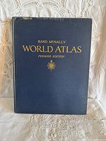 Front cover of navy blue hardcover atlas showing gilt title.