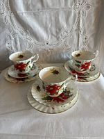 Three complete tea trios arranged showing pattern