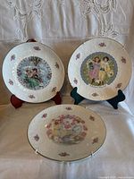 Front view of all three decorative plates on stands