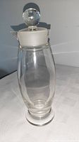 Full view of clear glass decanter with stopper