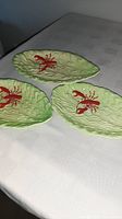 Three Carlton Ware leaf dishes on table