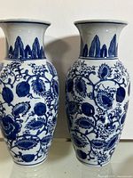 Both vases front view showing matching blue floral pattern and size