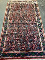 Full view of antique Senneh rug showing overall pattern and borders