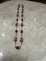 Full view of necklace laid flat showing overall design and bead arrangement