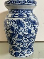 Front view of blue and white porcelain stool showing floral pattern and overall shape