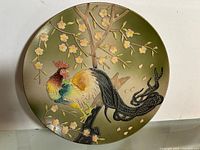 Full view of round moriage plate showing rooster and blossoms
