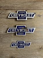 Front view of all three Chevrolet bowtie emblems showing size difference