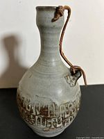 Full view of decanter front showing glaze and leather strap