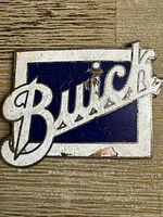 Front view of Buick emblem showing design and wear