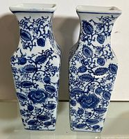 Front view of both square blue and white porcelain vases