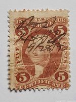 Front of 5¢ revenue stamp showing design, denomination and pen cancel