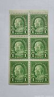 Front of vertical block of six 1¢ green Benjamin Franklin stamps
