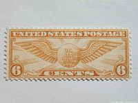 Front view of 6¢ orange Winged Globe airmail stamp
