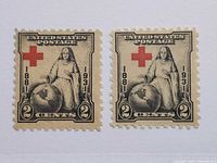 Front view of both 2¢ Red Cross stamps showing one with shifted red cross