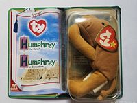 Front view of booklet opened showing Humphrey camel in blister and legend artwork