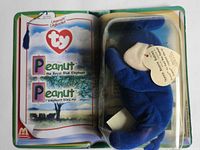 Front view showing Peanut plush inside blister and open book graphics