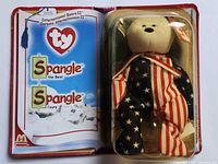 Open book-style package showing Spangle bear inside and left page graphics