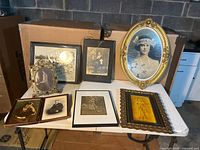 Group shot of all seven framed pictures on table