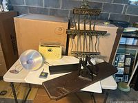 Overall lot showing shelves, stereo player, lamp and gauge