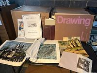 Overall lot with portfolio, catalogue, various prints on table
