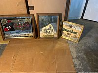 All three framed bar mirrors standing side by side on floor