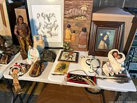 Wide view of entire collection on table and artworks behind