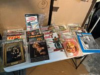 Tabletop view showing entire assortment of vintage magazines in sleeves
