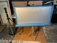 Tripod stand and projection screen side by side