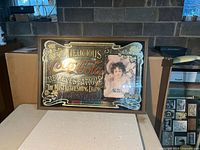 Full view of framed Coca-Cola glass sign on table