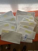 Group shot of folded fabric pieces with size/count labels visible