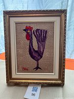 Front view of framed purple rooster tapestry