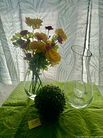 Group shot showing carafe, vase with flowers, and design details