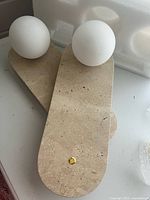 Two assembled sconces showing ceramic backplates and globes