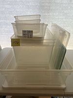 Overall view of nested clear plastic bins and lids