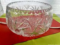 Side view showing scalloped rim and star cut pattern of crystal bowl