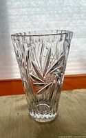 Full view of cut crystal vase showing starburst pattern and overall form