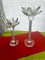 Front view of both crystal lotus candle holders showing height difference