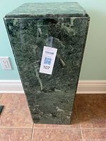 Full view of green marble pedestal stand showing height and marble veining