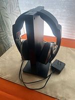 Headphones seated on vertical transmitter-charging stand