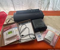 Overall lot showing vacuum sealer, two Honeywell thermostats, Sony clock radio, USB cable