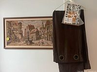 Framed tapestry, folded brown velvet curtain with grommets, two mosaic frames