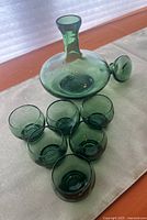 Decanter with stopper removed and six shot glasses displayed