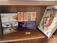 Three watercolor technique books on shelf