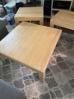 Three matching oak tables shown together highlighting style and size relationship
