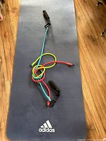 Full view of Adidas mat with resistance tubes and handles placed on top