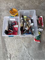 Overall lot showing two bins filled with painting tools and tubes of sealant