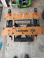 Top view showing Workmate 350 logo, wooden jaws, bench dogs, crank handles